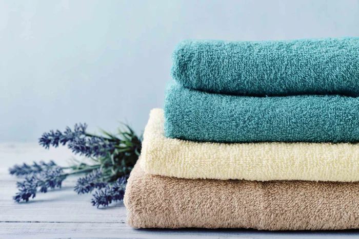 Person putting laundry drop into a washing machine